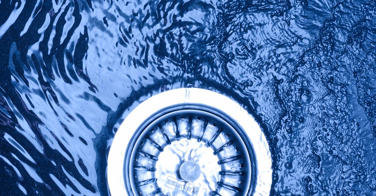 Copper-lined stainless steel vs pure copper skillet - Top view of colorful water fluid with rippled surface near stainless steel drain filter in sink Copper-lined stainless steel vs pure copper skillet - Top view of colorful water fluid with rippled surface near stainless steel drain filter in sink