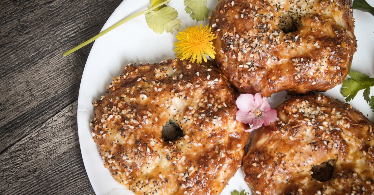 Coriander Seeds - Bagels in Plate with Flowers and Coriander Garnish Coriander Seeds - Bagels in Plate with Flowers and Coriander Garnish