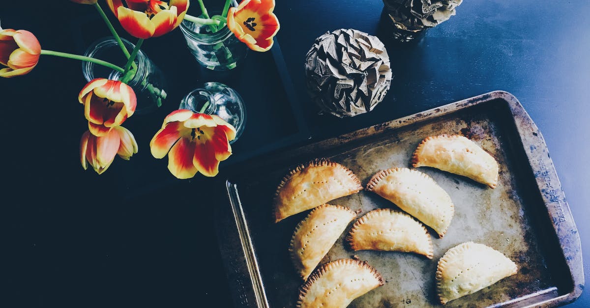 Costa Rican empanada-like food? - Yellow and Red Flower on Clear Glass Flower Vase Beside Brown Steel Tray With Pastry Costa Rican empanada-like food? - Yellow and Red Flower on Clear Glass Flower Vase Beside Brown Steel Tray With Pastry