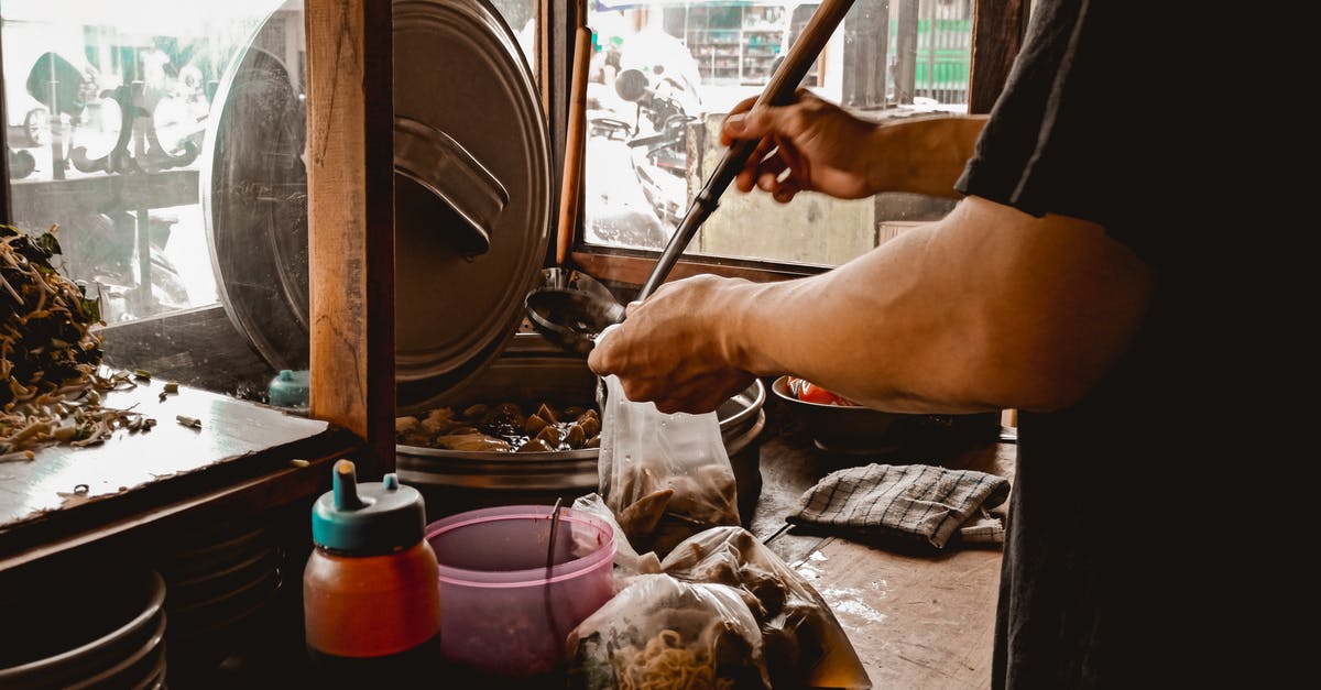 Counter to bitterness in soup - Man pouring soup in plastic bag while preparing Asian food Counter to bitterness in soup - Man pouring soup in plastic bag while preparing Asian food