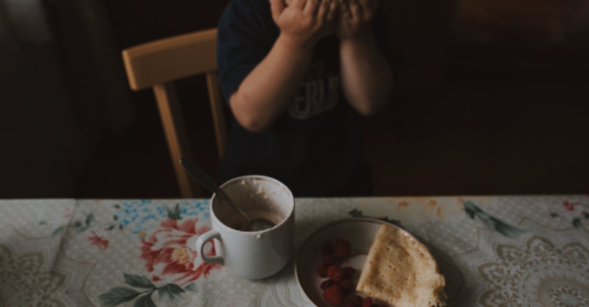 Covering food while cooling - Photograph of a Kid Covering His Eyes During Breakfast Covering food while cooling - Photograph of a Kid Covering His Eyes During Breakfast