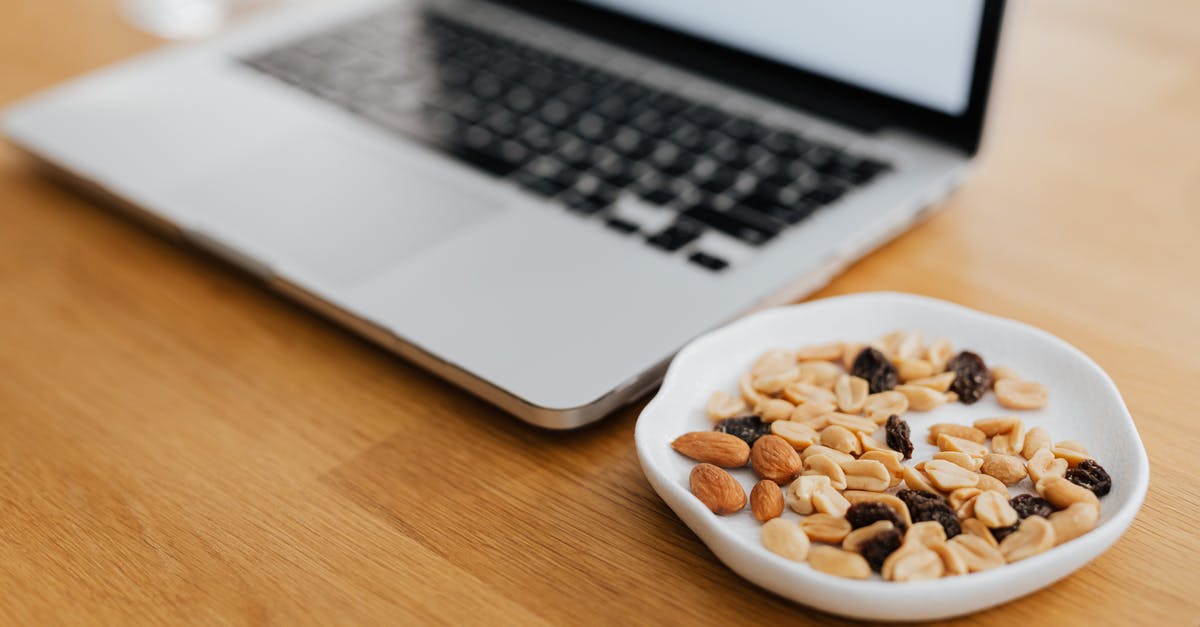 Cracking almonds without a nutcracker? - Macbook Pro on Brown Wooden Table Cracking almonds without a nutcracker? - Macbook Pro on Brown Wooden Table