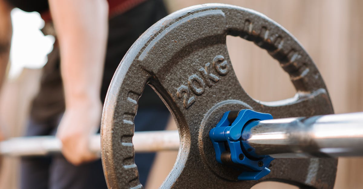 Cracks Developing in Straight-Sided Stainless Steel Vessels - Side view of crop anonymous male athlete preparing to lift barbell with stainless steel bar and plastic collar in daylight Cracks Developing in Straight-Sided Stainless Steel Vessels - Side view of crop anonymous male athlete preparing to lift barbell with stainless steel bar and plastic collar in daylight