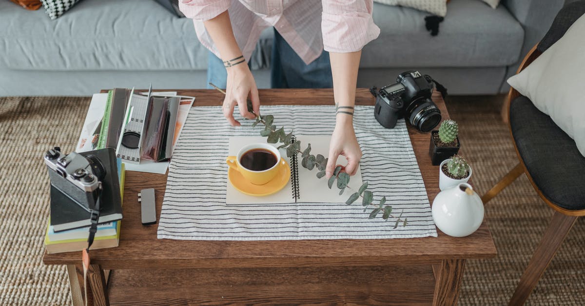 Create hot "sauce" from capsaicin extract - Crop faceless woman arranging coffee and twig on table Create hot "sauce" from capsaicin extract - Crop faceless woman arranging coffee and twig on table