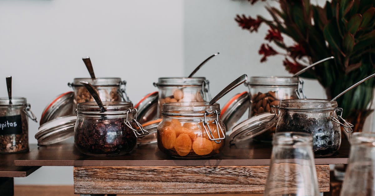 Crunchy vs Chewy dried apples? - Assorted dried fruits and nuts in transparent jars on table Crunchy vs Chewy dried apples? - Assorted dried fruits and nuts in transparent jars on table