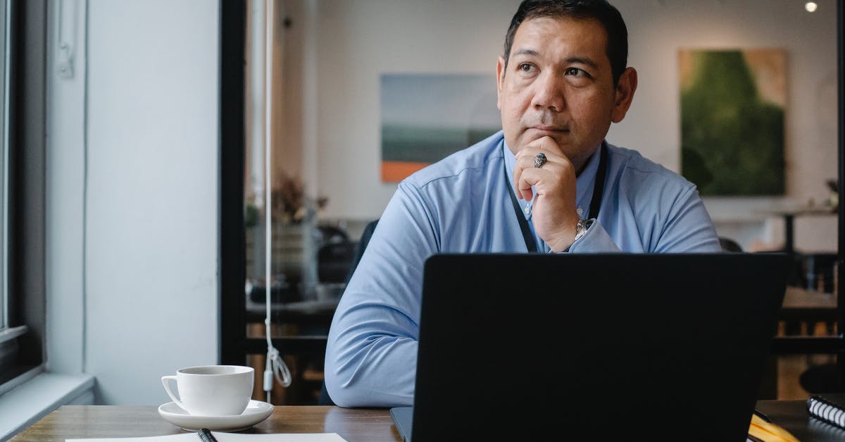 Cues to a reliable or unreliable recipe? - Thoughtful ethnic businessman using laptop while working in office