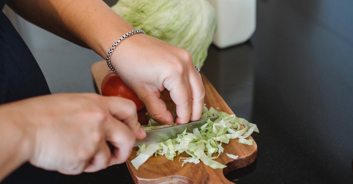 Culinary use for the green parts of lemongrass? - Female chopping lettuce leaves for salad Culinary use for the green parts of lemongrass? - Female chopping lettuce leaves for salad