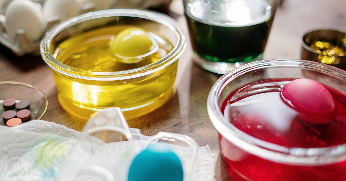 Cured Frozen Eggs - Eggs Dip in Clear Glass With Yellow Red and Green Liquid Cured Frozen Eggs - Eggs Dip in Clear Glass With Yellow Red and Green Liquid