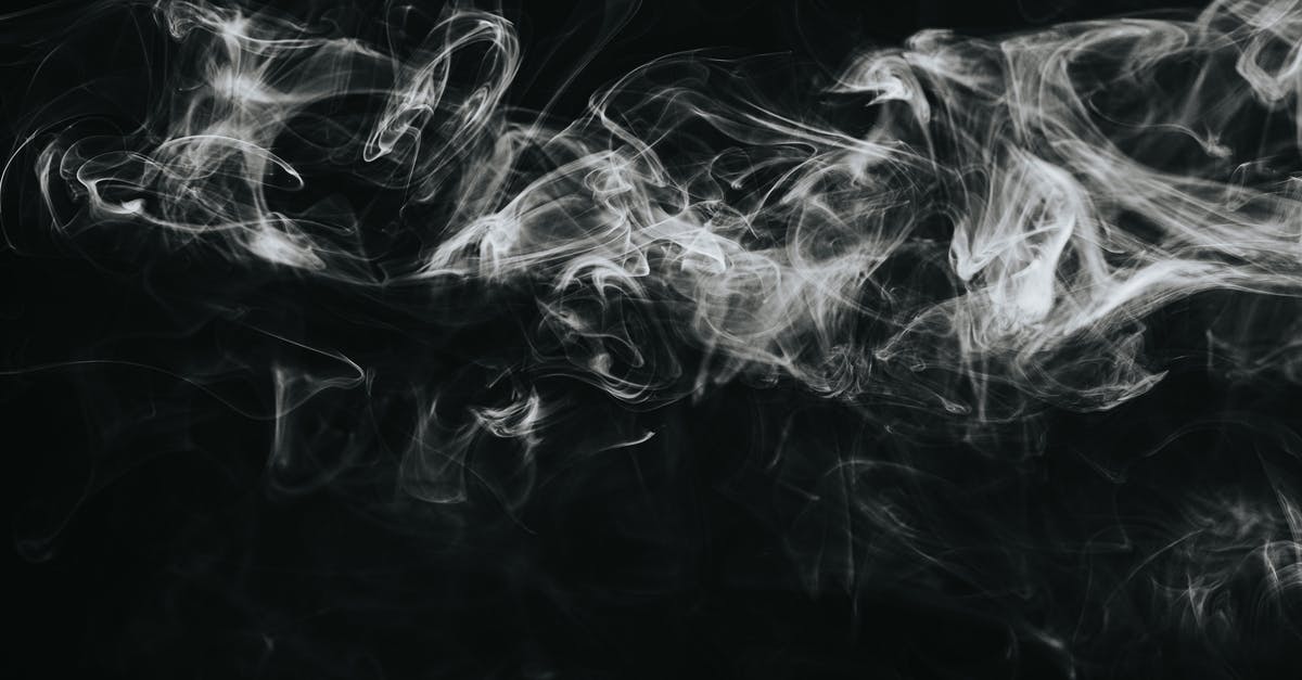 Date cookies are thin and spread out - White smoke against black background Date cookies are thin and spread out - White smoke against black background