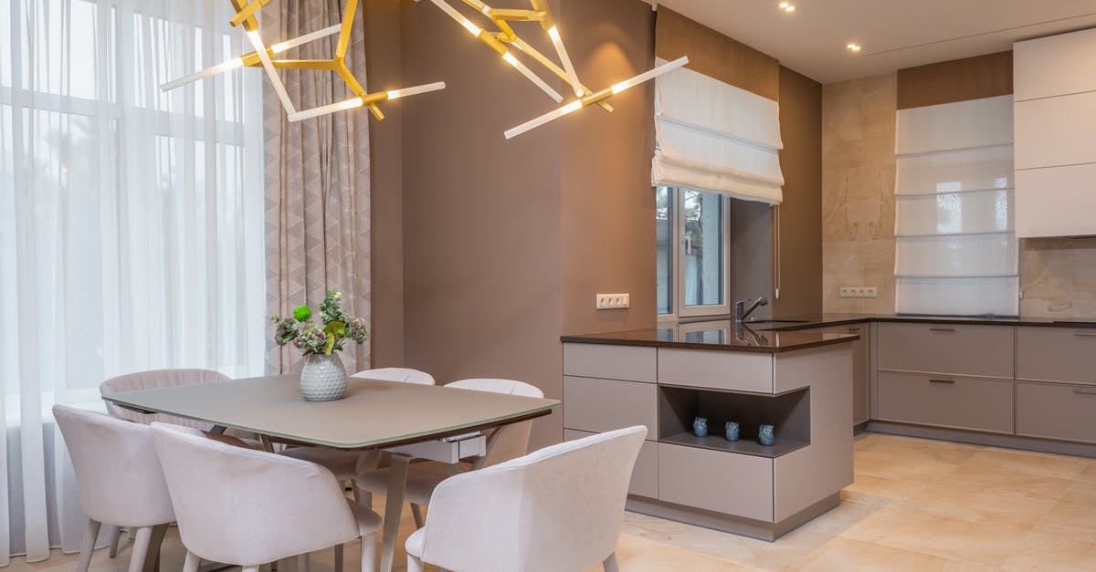 Deep frying with tallow in a stainless steel pot - Contemporary open plan kitchen with gray matte cabinets and dining table under contemporary geometric lamp in spacous apartment Deep frying with tallow in a stainless steel pot - Contemporary open plan kitchen with gray matte cabinets and dining table under contemporary geometric lamp in spacous apartment