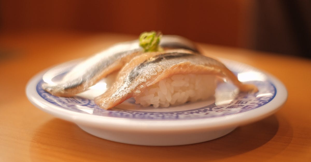 de-parasiting mackerel for sushi - Raw Fish with Sushi Rice on a Plate de-parasiting mackerel for sushi - Raw Fish with Sushi Rice on a Plate
