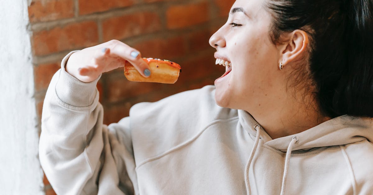 Determining sugar content of liqueurs - Crop excited woman eating fresh yummy donut Determining sugar content of liqueurs - Crop excited woman eating fresh yummy donut