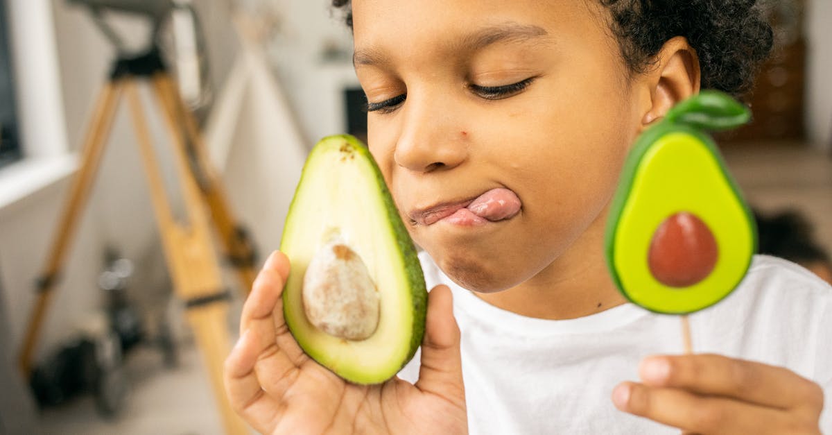 Determining sugar content of liqueurs - Positive black boy with lollipop and avocado Determining sugar content of liqueurs - Positive black boy with lollipop and avocado