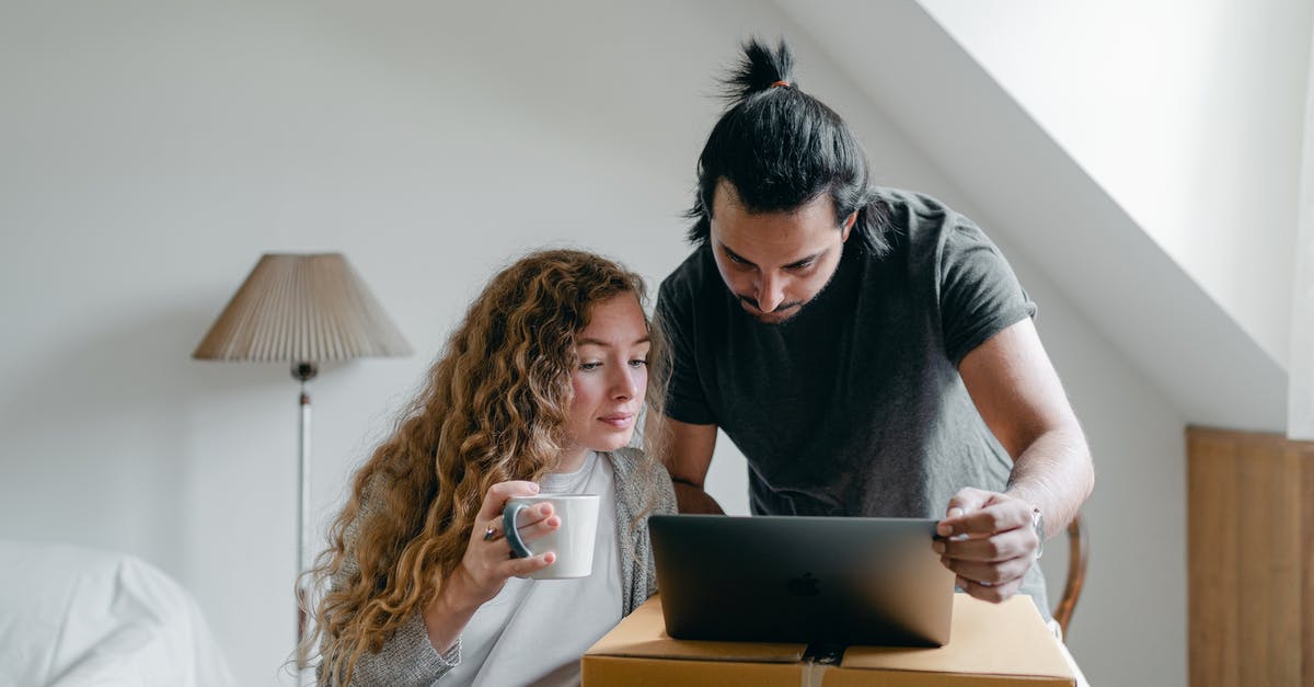 Device to squeeze last yogurt out of carton - Concentrated young couple in casual outfit browsing netbook and packing stuff into carton boxes and suitcases to move out Device to squeeze last yogurt out of carton - Concentrated young couple in casual outfit browsing netbook and packing stuff into carton boxes and suitcases to move out