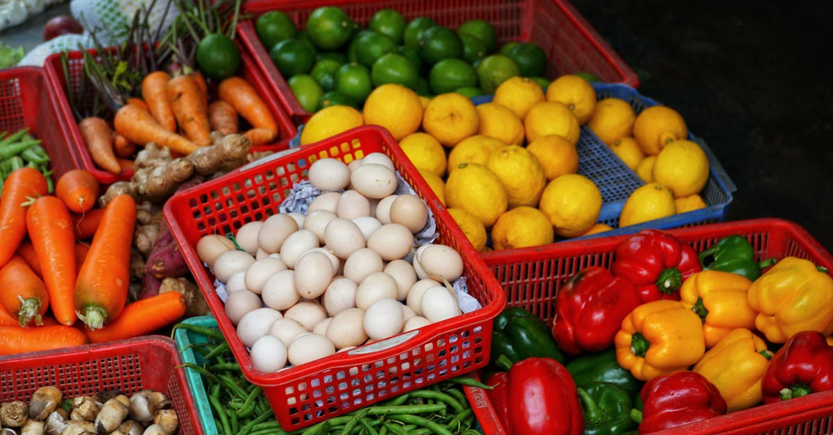 Difference between chicken and duck eggs? - From above of collection of colorful ripe vegetables and citrus fruits in plastic boxes in street market Difference between chicken and duck eggs? - From above of collection of colorful ripe vegetables and citrus fruits in plastic boxes in street market