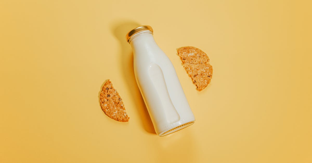 Difference between natural and organic - Bottle of milk with cookies on surface Difference between natural and organic - Bottle of milk with cookies on surface