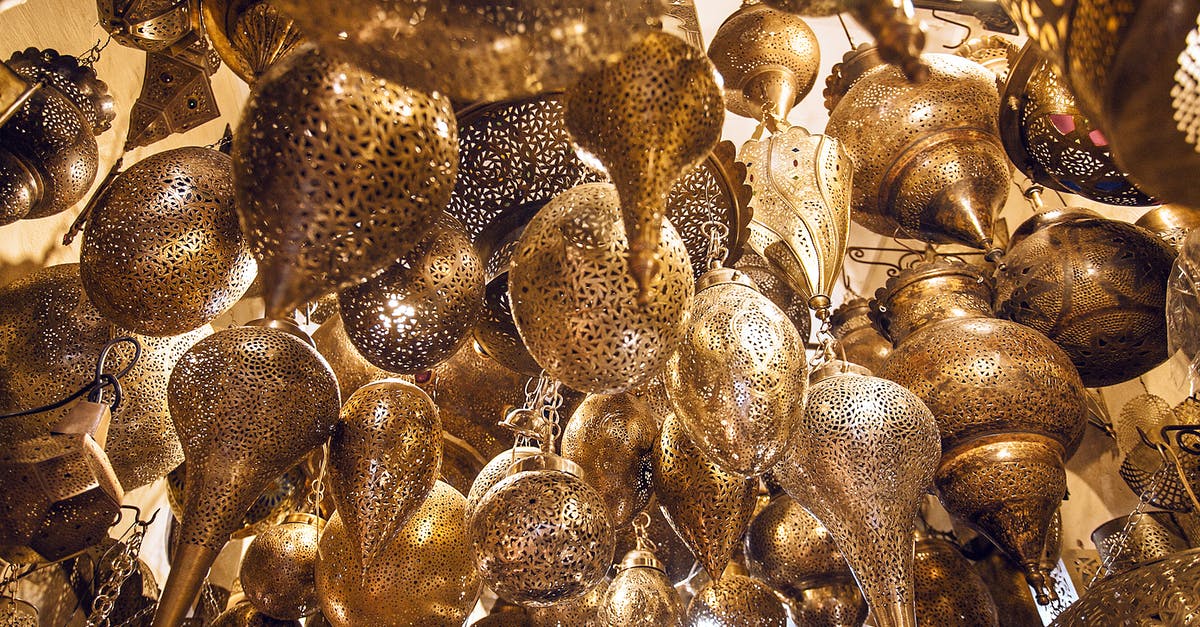 Difference between Vietnamese and Moroccan preserved lemons? - From below of assorted ornamental Moroccan lamps with tiny holes on shiny surface in local market