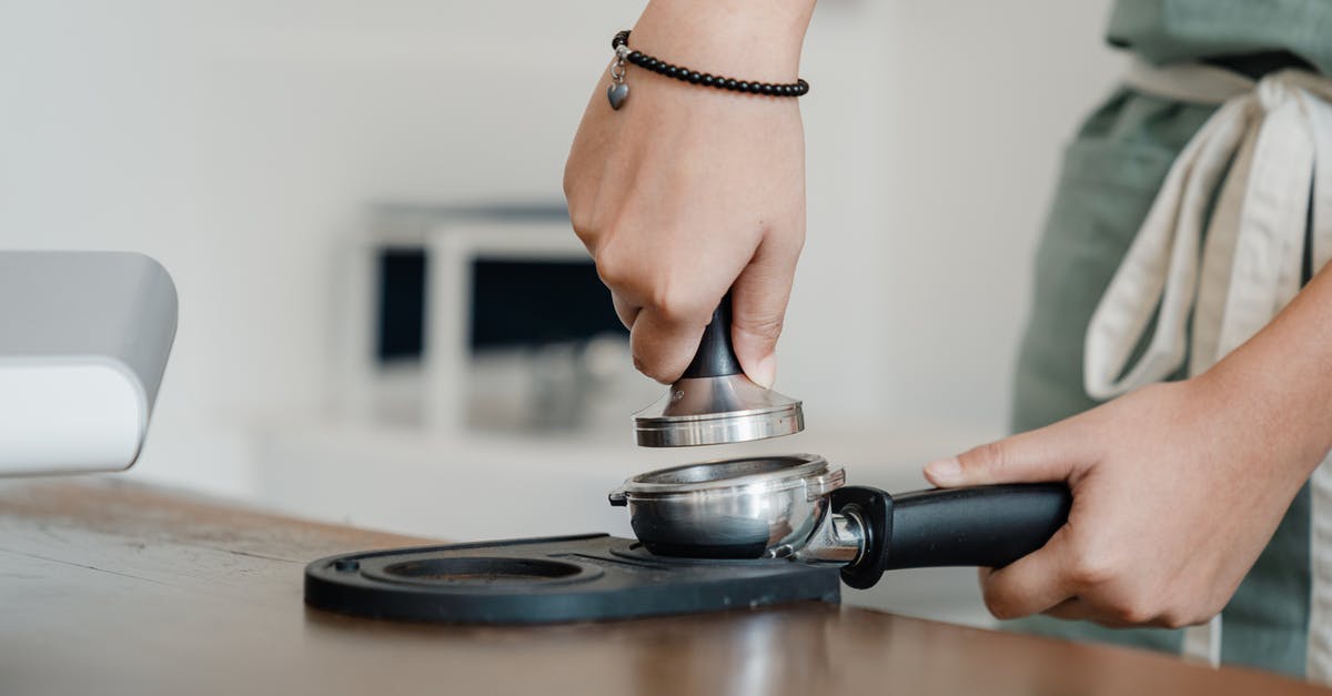 Differences between coffee made with french press or espresso machine? - Crop barista working with tamper and coffee machine holder Differences between coffee made with french press or espresso machine? - Crop barista working with tamper and coffee machine holder