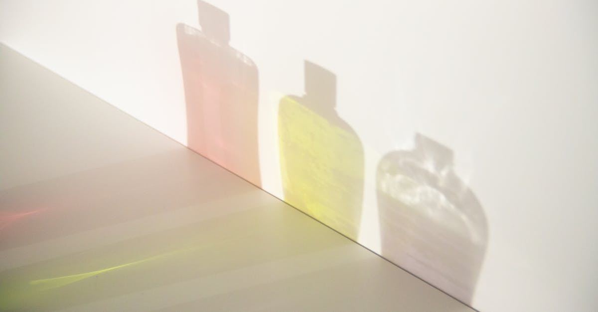 Differences between gel and gelatine - From above of different bottle shadows with bright liquids and caps in row on smooth surface