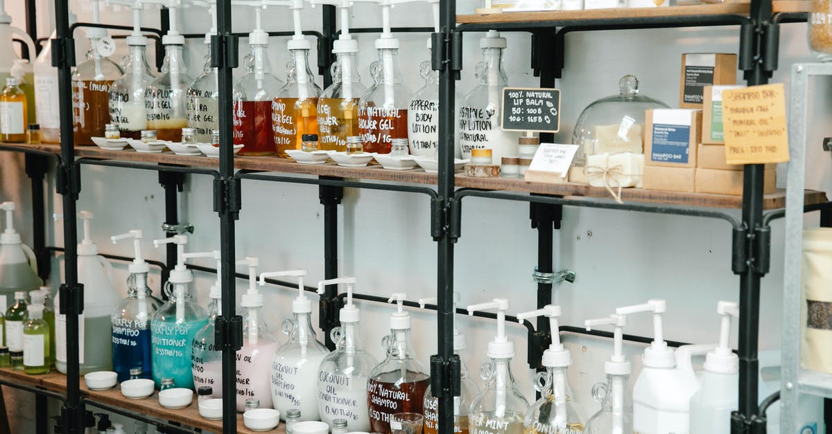 Differences between gel and gelatine - Collection of different plastic bottles with multicolored soap placed on shelves in zero waste shop