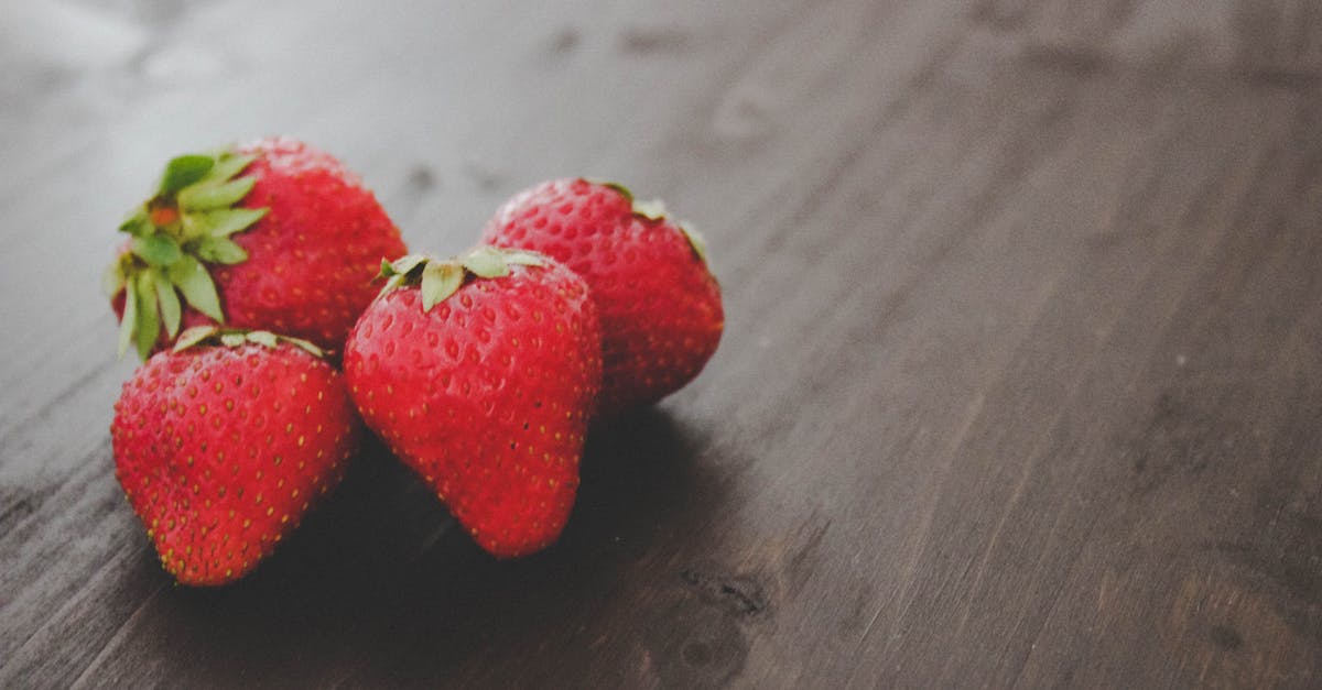 differences in caper berry seeds - Ripe strawberries heap on wooden table differences in caper berry seeds - Ripe strawberries heap on wooden table