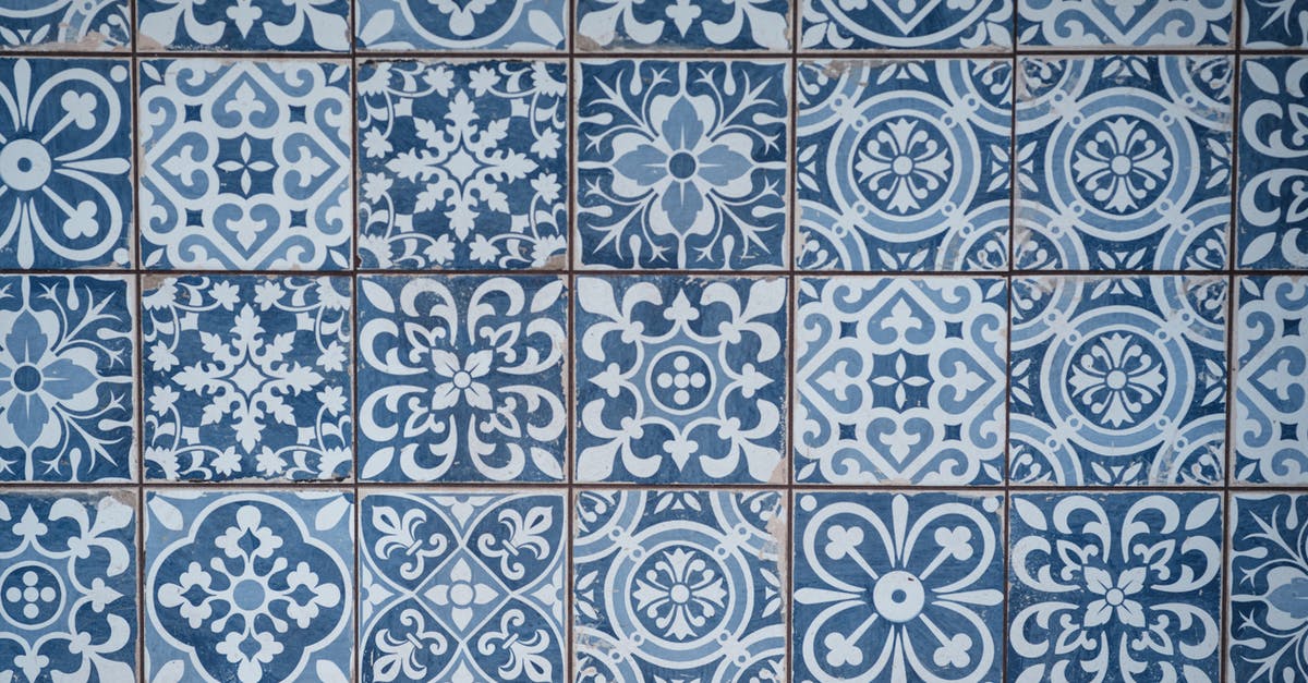 Different ways for aging steaks - Aged wall covered with ceramic square shaped tile with many blue different ornaments Different ways for aging steaks - Aged wall covered with ceramic square shaped tile with many blue different ornaments