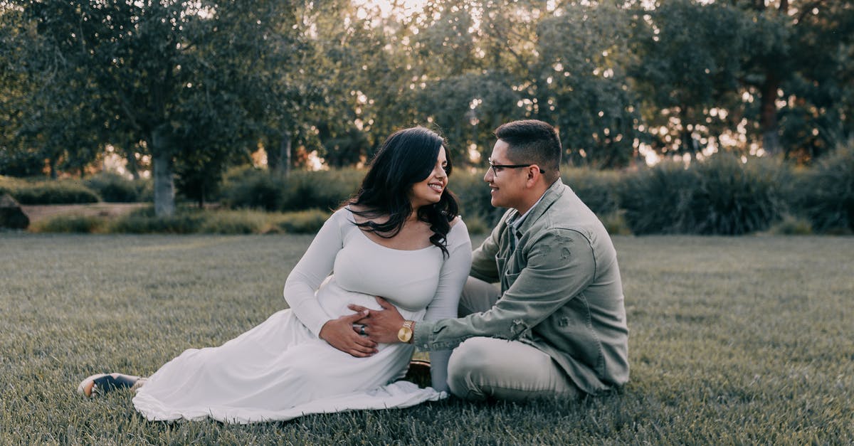 Discolored ring in squash - Couple Sitting on Green Grass Field