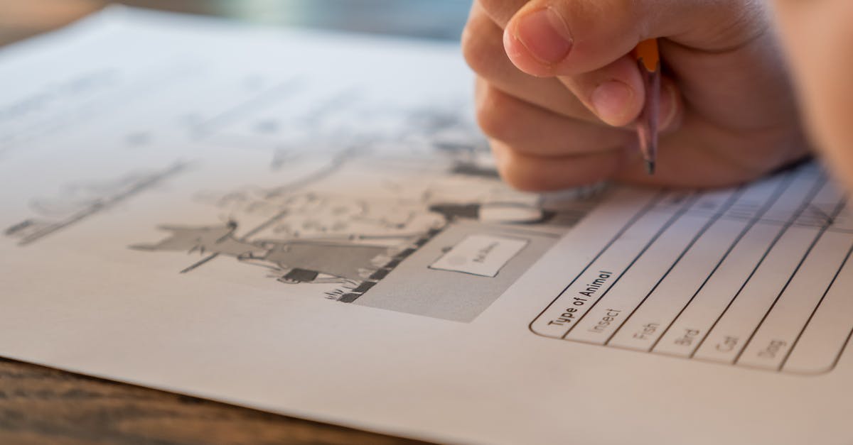Discworld cookbook question [closed] - Closeup of crop anonymous elementary school pupil with pencil in hand doing marks on paper sheet with test about animals during lesson