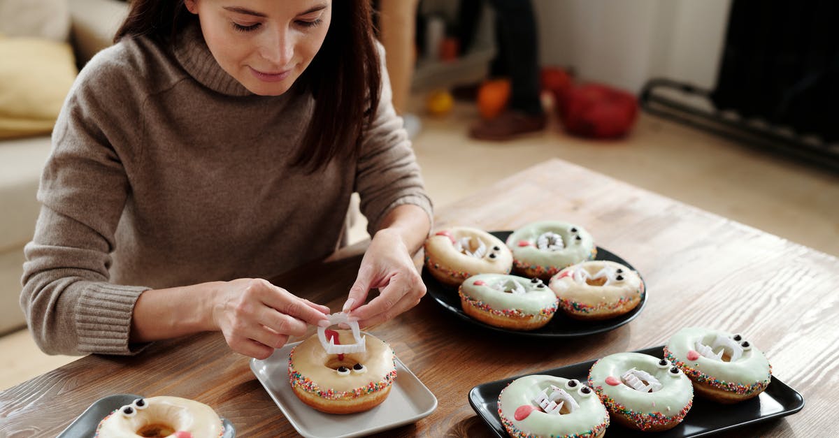 DIY Baking Steel? - Woman Placing A Plastic Fang On A Donut DIY Baking Steel? - Woman Placing A Plastic Fang On A Donut