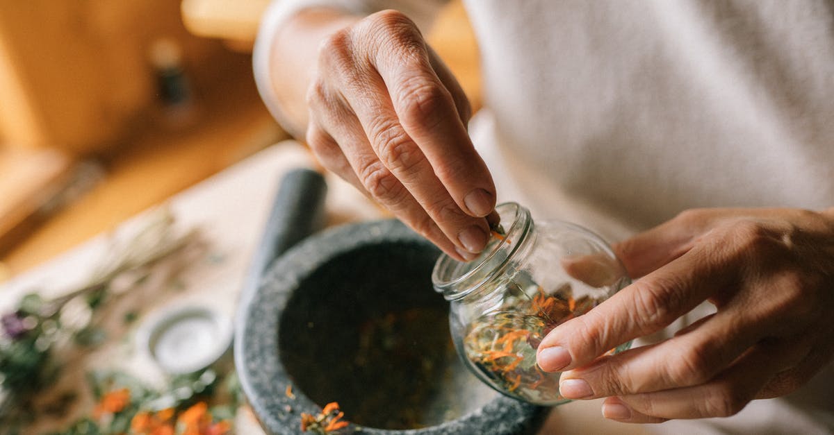 DIY herb preservation - A Person Holding a Glass Container DIY herb preservation - A Person Holding a Glass Container