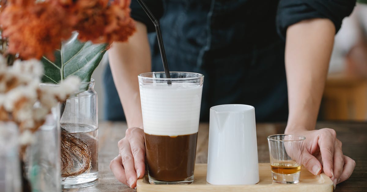 Do all varieties of cocoa naturally taste bitter? - Crop unrecognizable woman serving iced coffee with shot of cognac Do all varieties of cocoa naturally taste bitter? - Crop unrecognizable woman serving iced coffee with shot of cognac