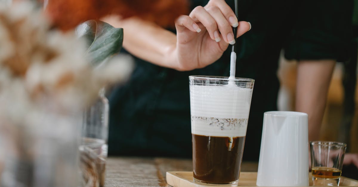 Do all varieties of cocoa naturally taste bitter? - Crop unrecognizable woman putting straw in glass of iced latte Do all varieties of cocoa naturally taste bitter? - Crop unrecognizable woman putting straw in glass of iced latte