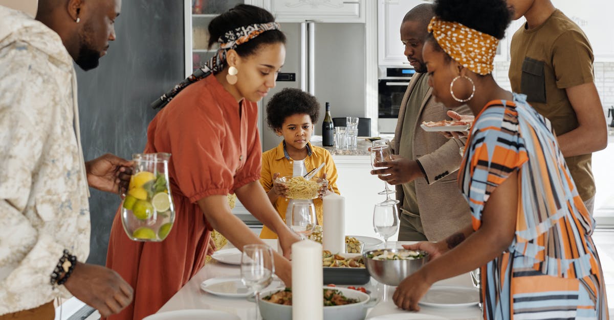Do dishes used for preparing food need to be washed with soap? - Family Setting the Table for Dinner