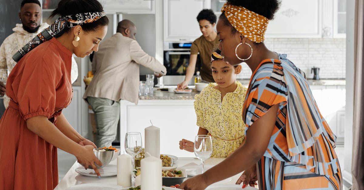 Do dishes used for preparing food need to be washed with soap? - Family Setting the Table for Dinner