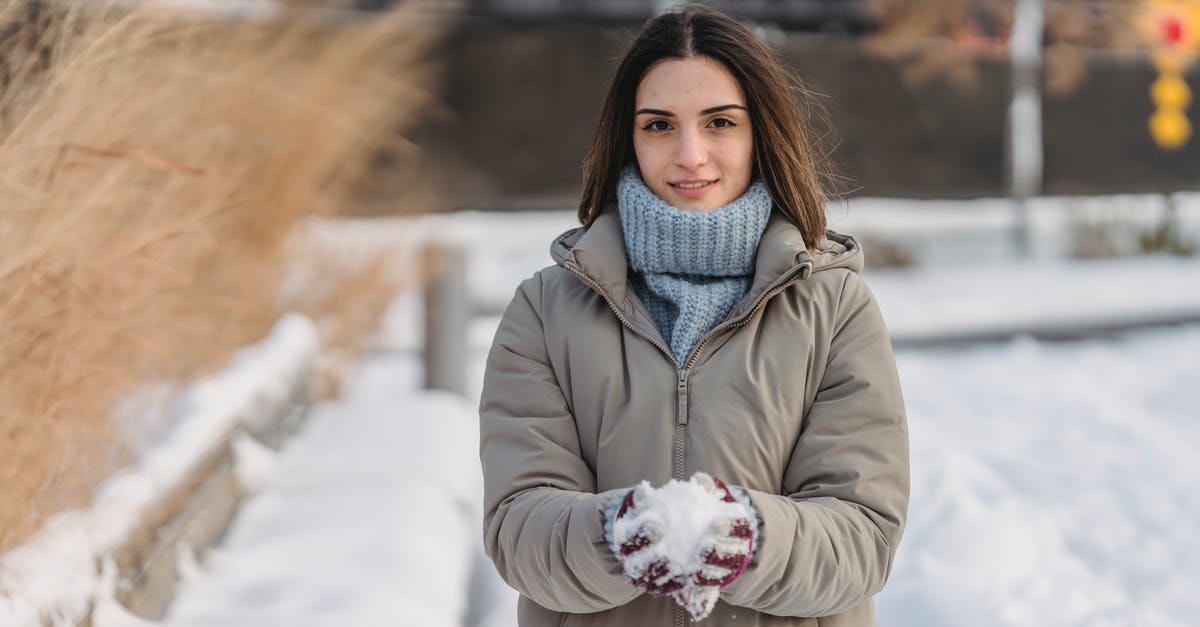 Do I have to wait for frozen steak to defrost? - Content young female wearing warm clothes and mittens in warm clothes holding snow in hands spending winter day in city park and looking at camera Do I have to wait for frozen steak to defrost? - Content young female wearing warm clothes and mittens in warm clothes holding snow in hands spending winter day in city park and looking at camera