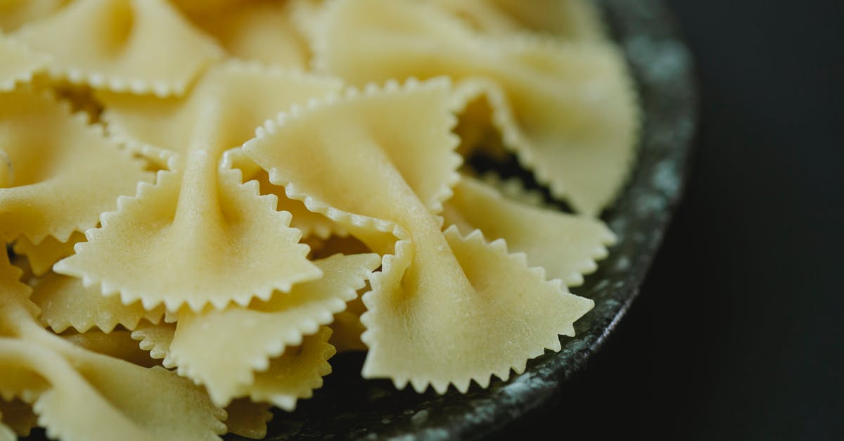 Do I need to let ravioli made with fresh dough dry? - High angle of raw dried traditional Italian farfalle pasta in bowl on black background Do I need to let ravioli made with fresh dough dry? - High angle of raw dried traditional Italian farfalle pasta in bowl on black background