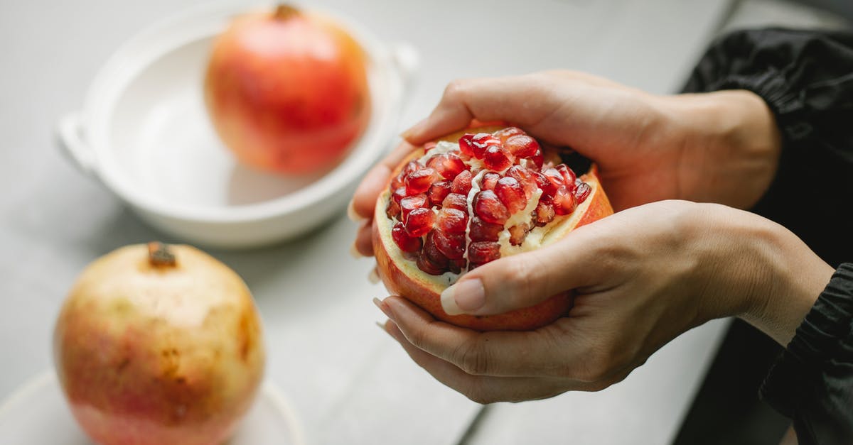 Do I need to peel a red kuri squash? - Crop woman with peeled pomegranate in hands Do I need to peel a red kuri squash? - Crop woman with peeled pomegranate in hands