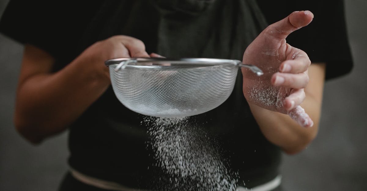 Do I need to sift flour that is labeled sifted? - Crop anonymous cook in apron sifting flour while preparing baking dish against gray background Do I need to sift flour that is labeled sifted? - Crop anonymous cook in apron sifting flour while preparing baking dish against gray background