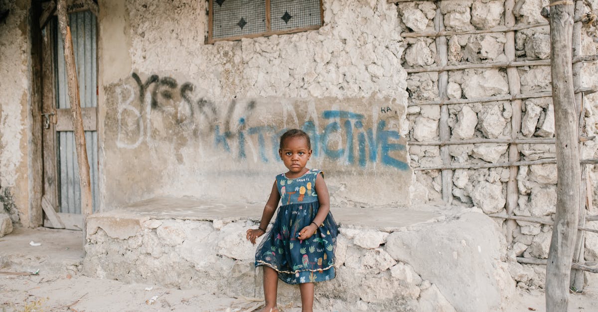 Do leeks need to be softened? - Little black girl sitting on rough stone border in ghetto Do leeks need to be softened? - Little black girl sitting on rough stone border in ghetto