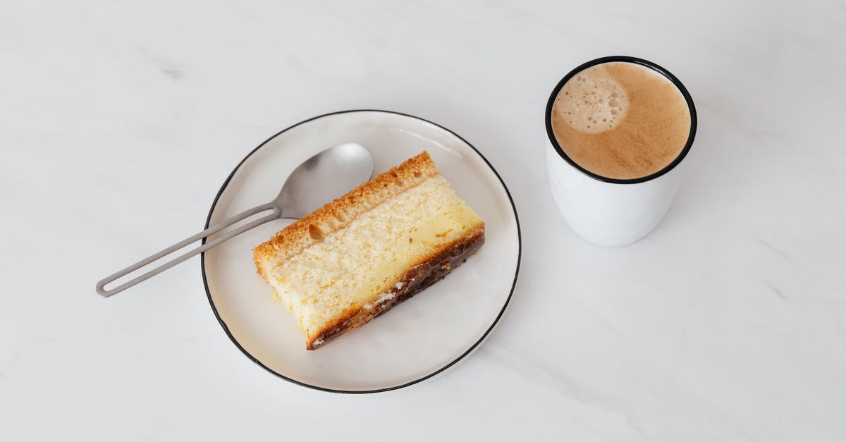 Do these lines in ceramic pie plate mean cracks? - From above of cup of hot coffee near white plate with delicious piece of cake placed on white marble tabletop Do these lines in ceramic pie plate mean cracks? - From above of cup of hot coffee near white plate with delicious piece of cake placed on white marble tabletop