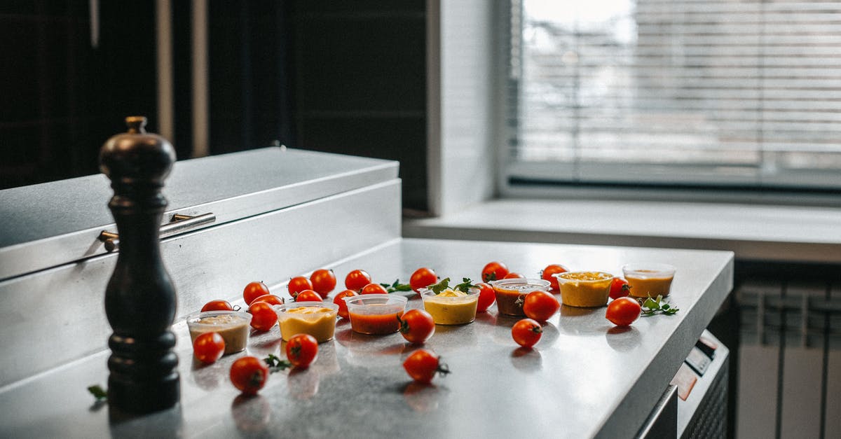 Do tomato-based sauces change/enhance flavour when left in the fridge? - Red Tomatoes and Sauces on a Kitchen Counter Do tomato-based sauces change/enhance flavour when left in the fridge? - Red Tomatoes and Sauces on a Kitchen Counter