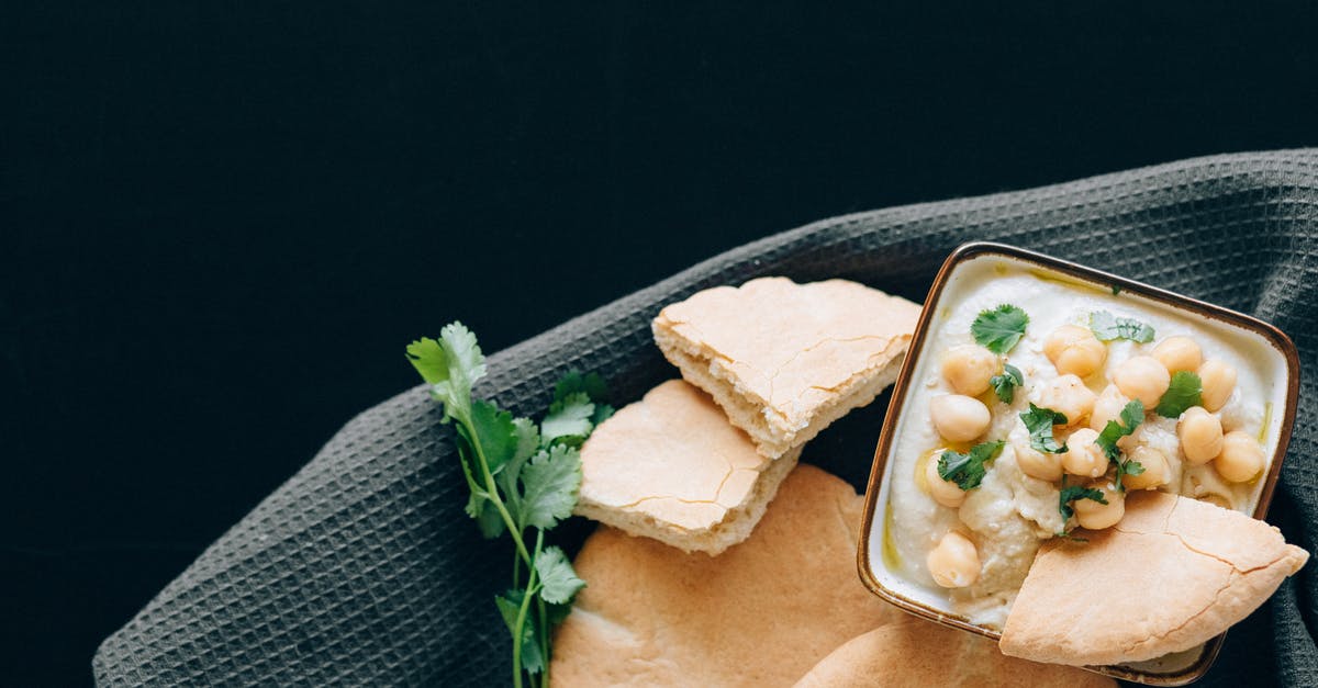 Do you peel garbanzo beans for hummus? - Close-Up Photo of Bread Dipped in Hummus