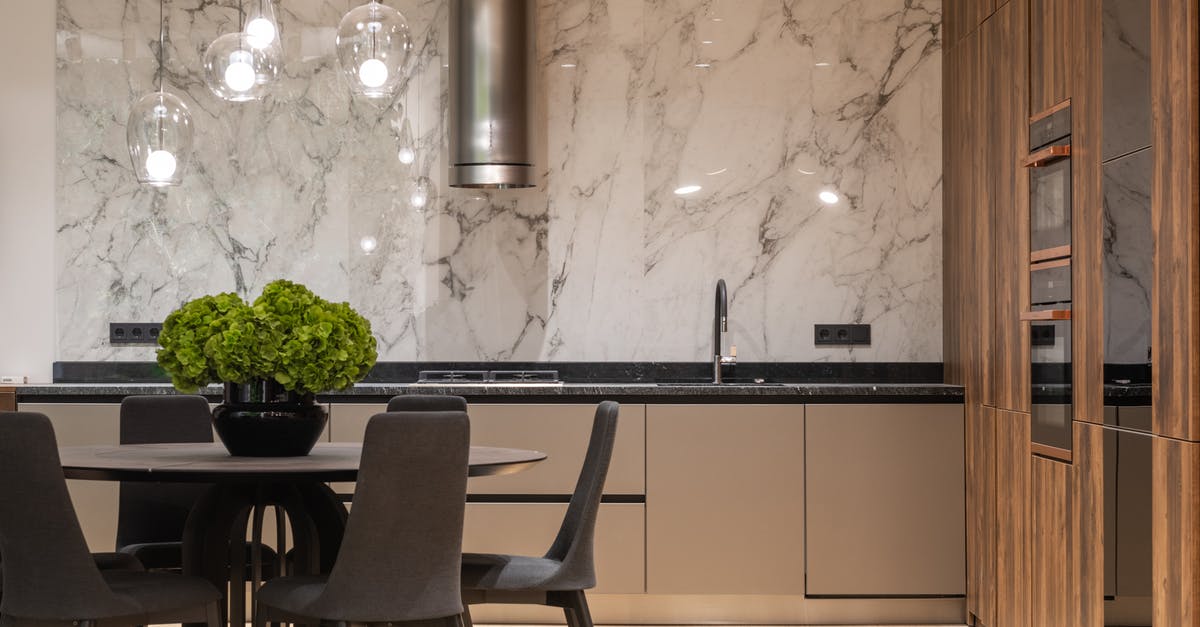 Does a colder refrigerator keep things fresh longer? - Interior of stylish kitchen with minimalist furniture and round table with chairs Does a colder refrigerator keep things fresh longer? - Interior of stylish kitchen with minimalist furniture and round table with chairs
