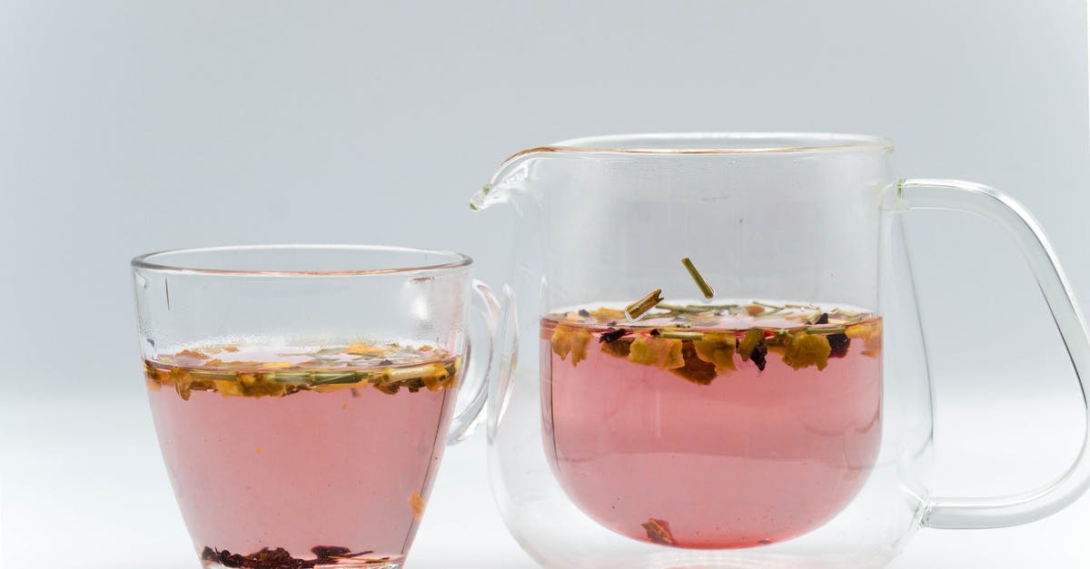Does a double walled glass mug really keep the liquid warm? - Glass transparent teapot with fresh brewed herbal tea placed near cup in studio Does a double walled glass mug really keep the liquid warm? - Glass transparent teapot with fresh brewed herbal tea placed near cup in studio