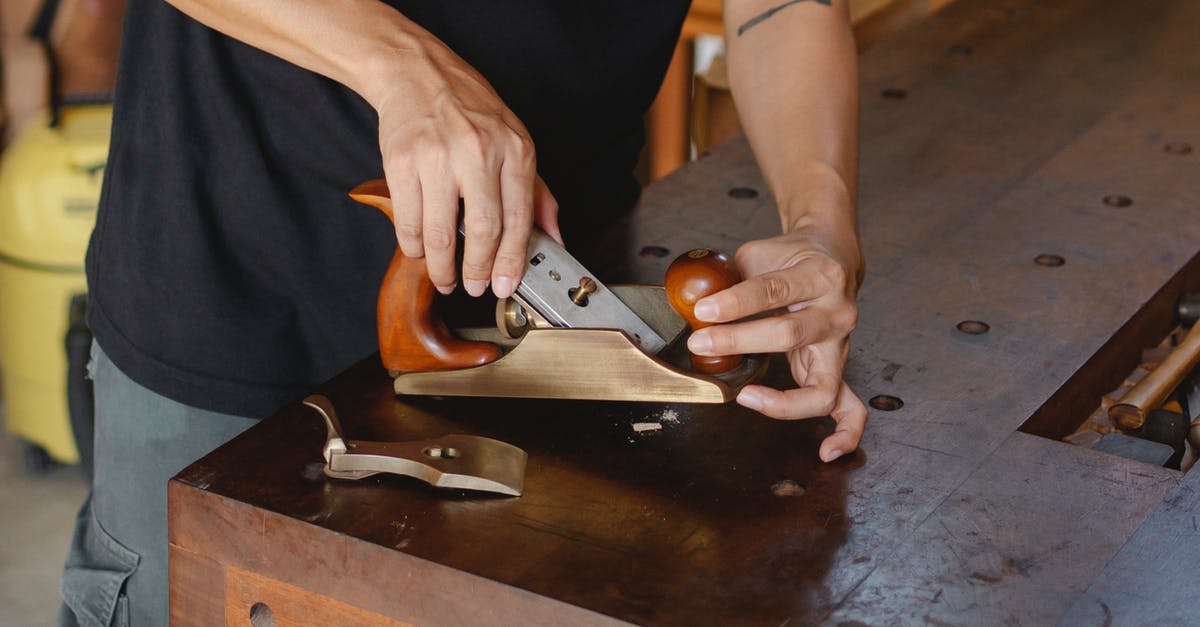 Does a silicone cutting board really work well? - Anonymous male carpenter with tattoo adjusting knife in planer for cutting wood during work in professional workshop on blurred background Does a silicone cutting board really work well? - Anonymous male carpenter with tattoo adjusting knife in planer for cutting wood during work in professional workshop on blurred background