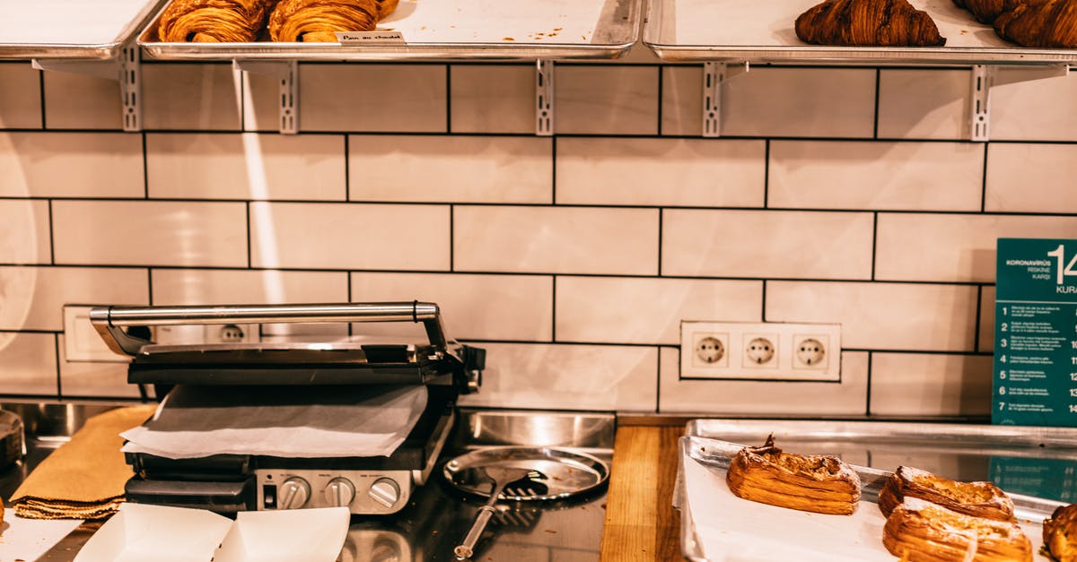 Does an electric grill make it faster than a pan? - Assorted tasty puffs and croissants on metal trays above electric grill on table in cafeteria Does an electric grill make it faster than a pan? - Assorted tasty puffs and croissants on metal trays above electric grill on table in cafeteria