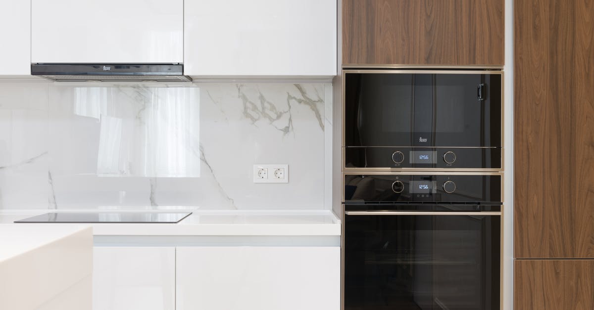 Does an induction stove require flat bottomed vessels? - Modern interior of white and wooden kitchen with cabinets cupboards and built in appliances in contemporary flat Does an induction stove require flat bottomed vessels? - Modern interior of white and wooden kitchen with cabinets cupboards and built in appliances in contemporary flat