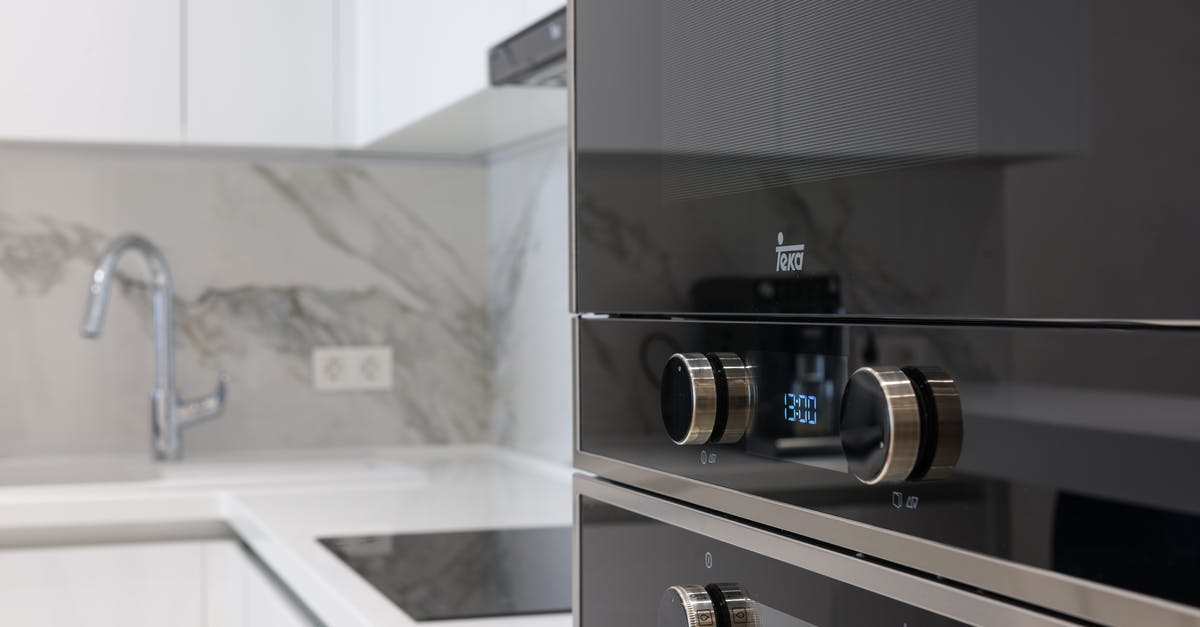 Does an induction stove require flat bottomed vessels? - Interior of contemporary kitchen with stainless white surface induction cooker and electronic stove in modern apartment Does an induction stove require flat bottomed vessels? - Interior of contemporary kitchen with stainless white surface induction cooker and electronic stove in modern apartment