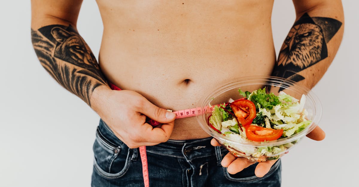Does blanching cause loss of mass/weight in the vegetable? - Topless Man Holding a Sliced Tomato and Fresh Vegetable Salad Does blanching cause loss of mass/weight in the vegetable? - Topless Man Holding a Sliced Tomato and Fresh Vegetable Salad