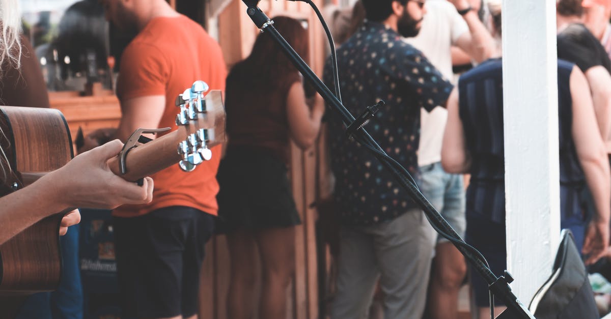 Does kimchi always have live cultures? - Crop anonymous person with acoustic guitar at festival with many people in daytime Does kimchi always have live cultures? - Crop anonymous person with acoustic guitar at festival with many people in daytime